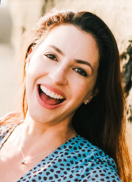 Iva Perez smiling on a beach